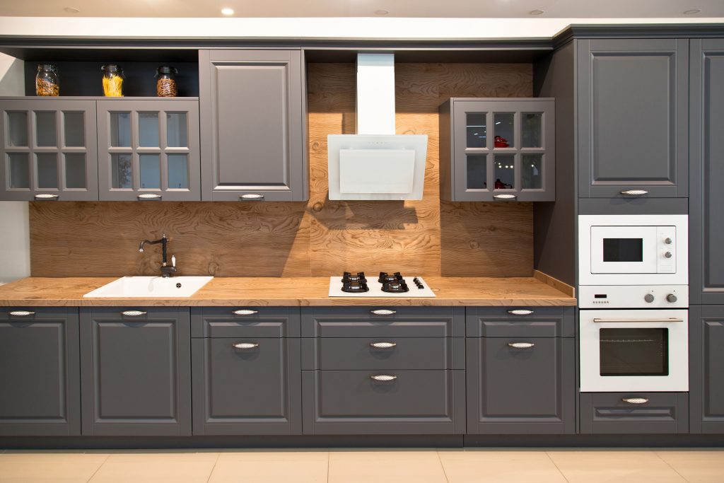 Interior of modern kitchen equipment and grey cabinets